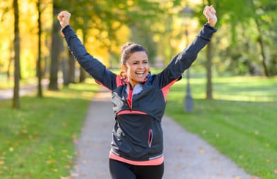 A happy woman jogging