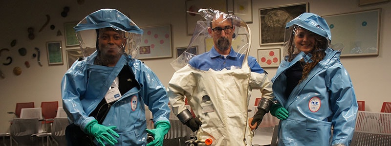 Fellows try on biosafety suits during a tour of the David J. Sencer CDC Museum