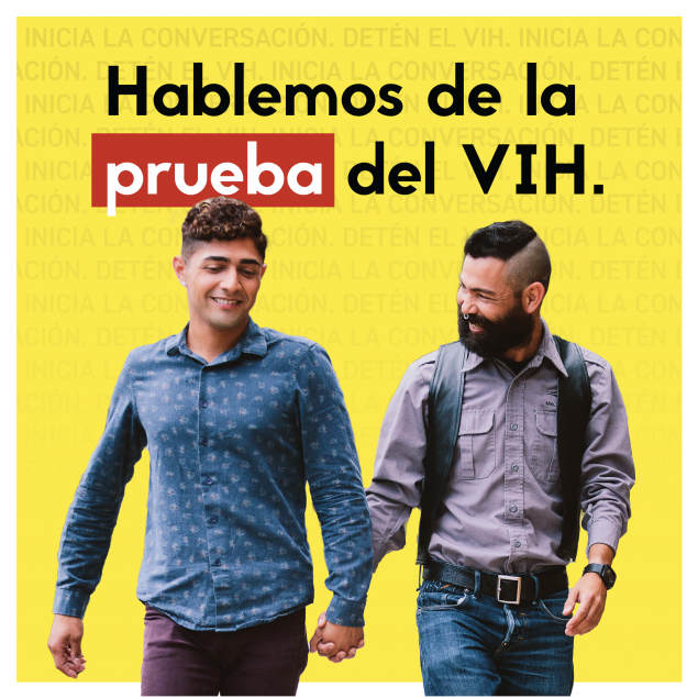 Two men holding hands while walking together.  Text (Spanish): Hablemos de la prueba del VIH.