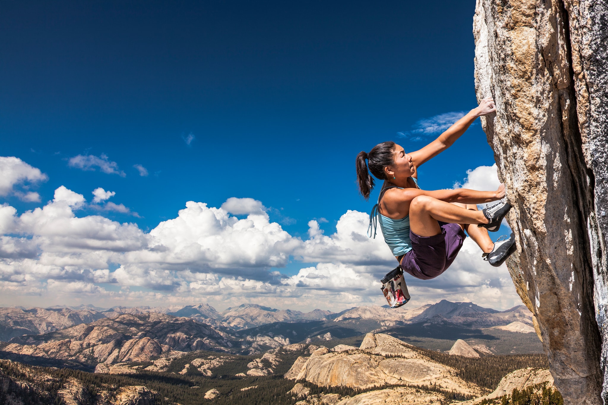 woman climbing outdoor rock wall