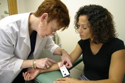 Nurse reading a patient's skin test