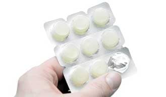 cessation medication lozenges pack being held by a hand