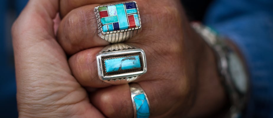 turquoise inlay rings on a hand