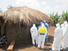 Healthcare workers dressed in protective gear in a village in Africa