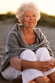 Smiling elderly lady on beach