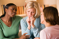 Woman being comforted by friends