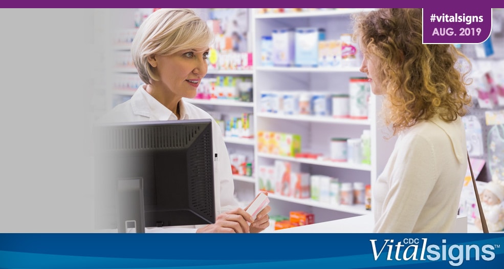 A pharmacist talks with a patient about a prescription.