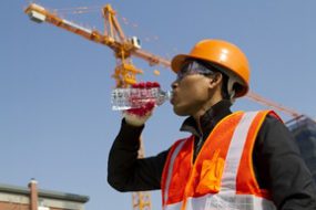 Construction worker drinking bottled water