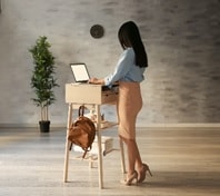 Employee using standing at high top work station