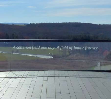 A poignant view of the Flight 93 Memorial's Flight path overlook, featuring a glass barrier inscribed with the powerful quote &quote; A common field one day. A field of honor forever.&quote; The scene pays tribute and stands as lasting symbol of honor and remembrance. 
