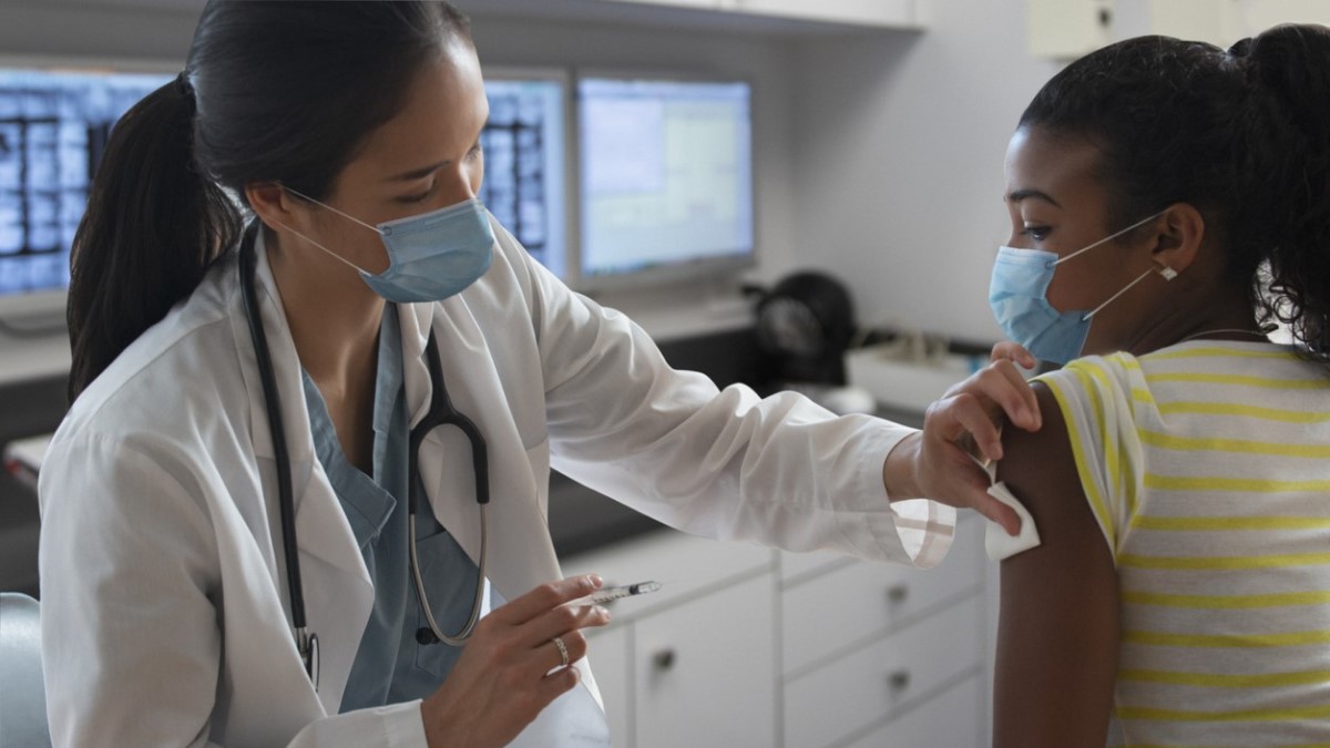 Photo of a doctor giving an HPV vaccine to a girl