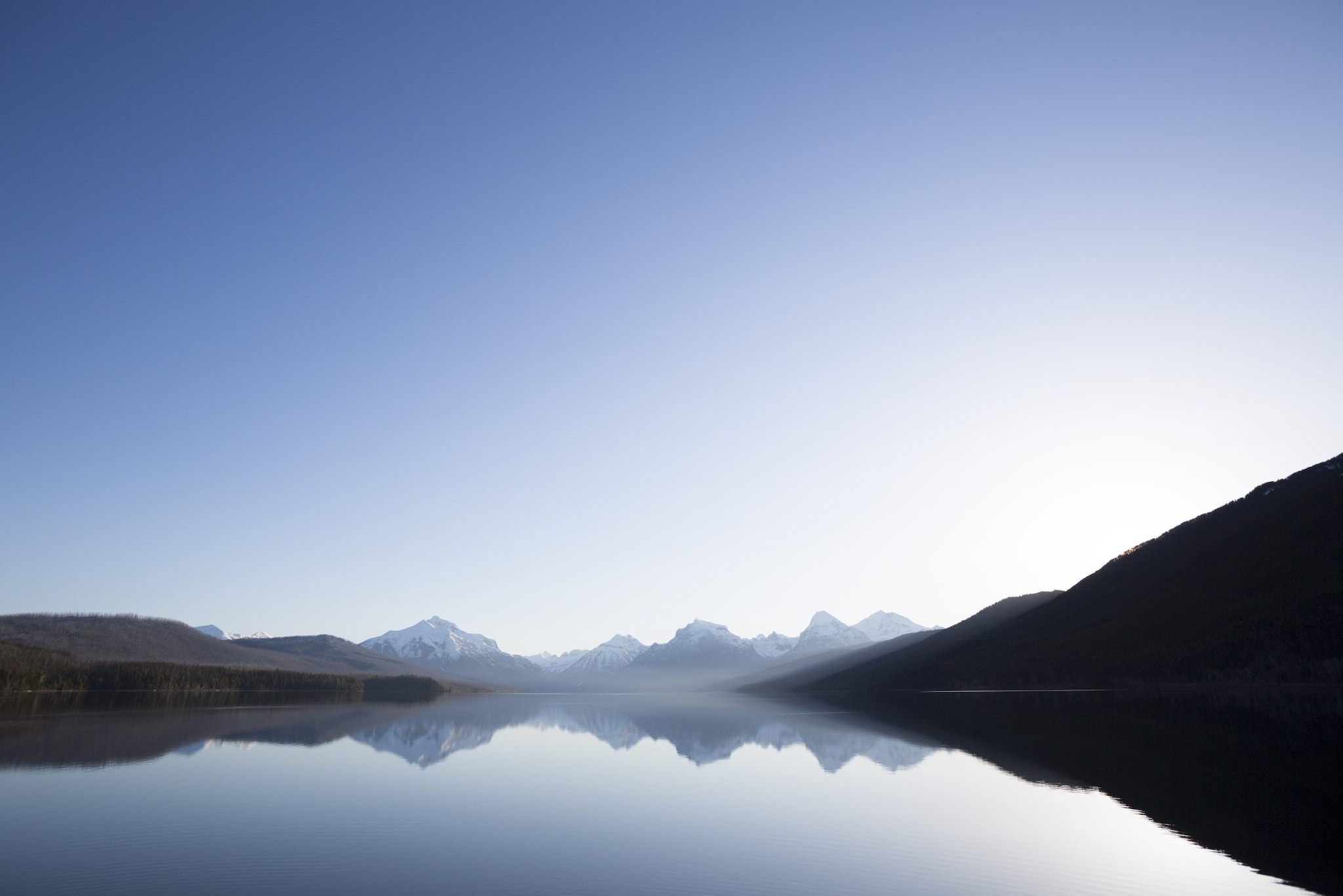 Calm morning sunrise over a lake in Glacier National Park