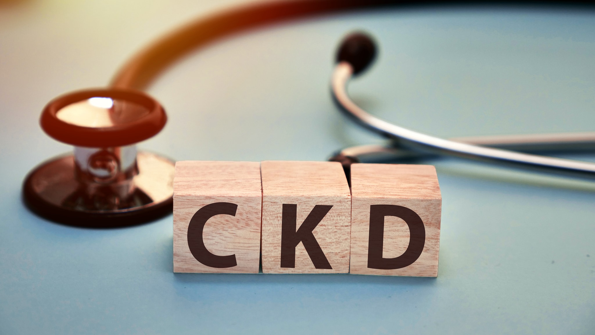 Blocks printed with the letters C, K and D next to a stethoscope