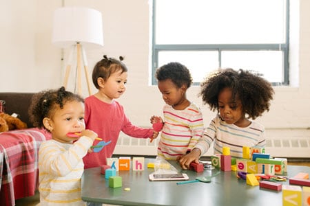 Young children playing with blocks at a daycare.