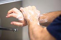 Adult scrubbing their hands well.