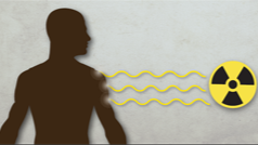 A silhouette of a man being hit with waves of toxic radiation.