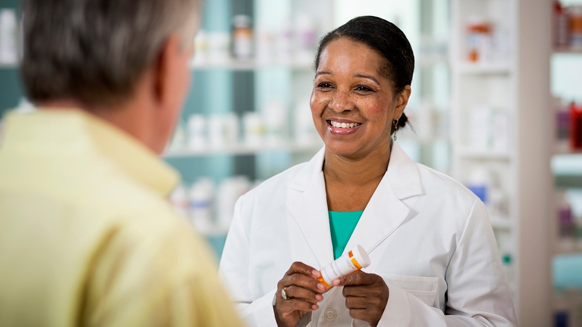 Pharmacist talking to patient about a prescription