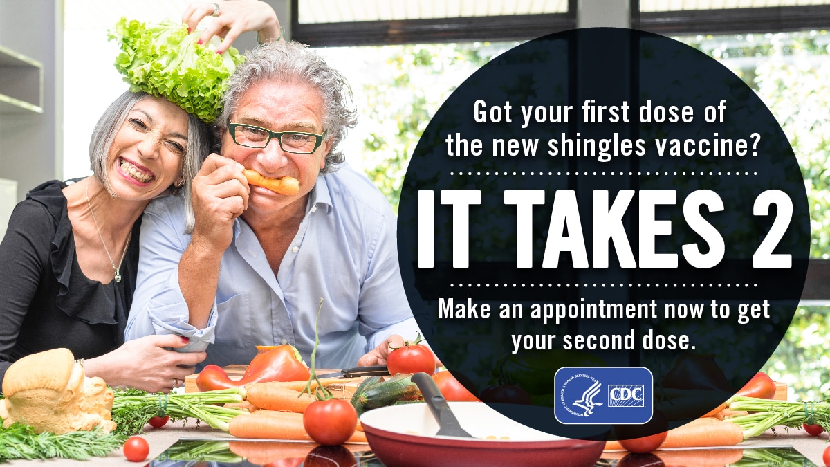 A couple with produce smiling in the kitchen. Text reads: Got your first dose of the new shingles vaccine? It takes 2. Make an appointment now to get your second dose.