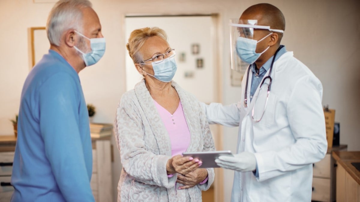 Photo of a man and a woman talking to a doctor