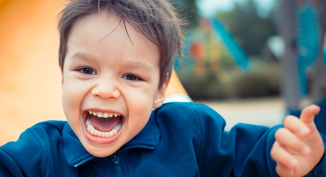 boy laughing on playground