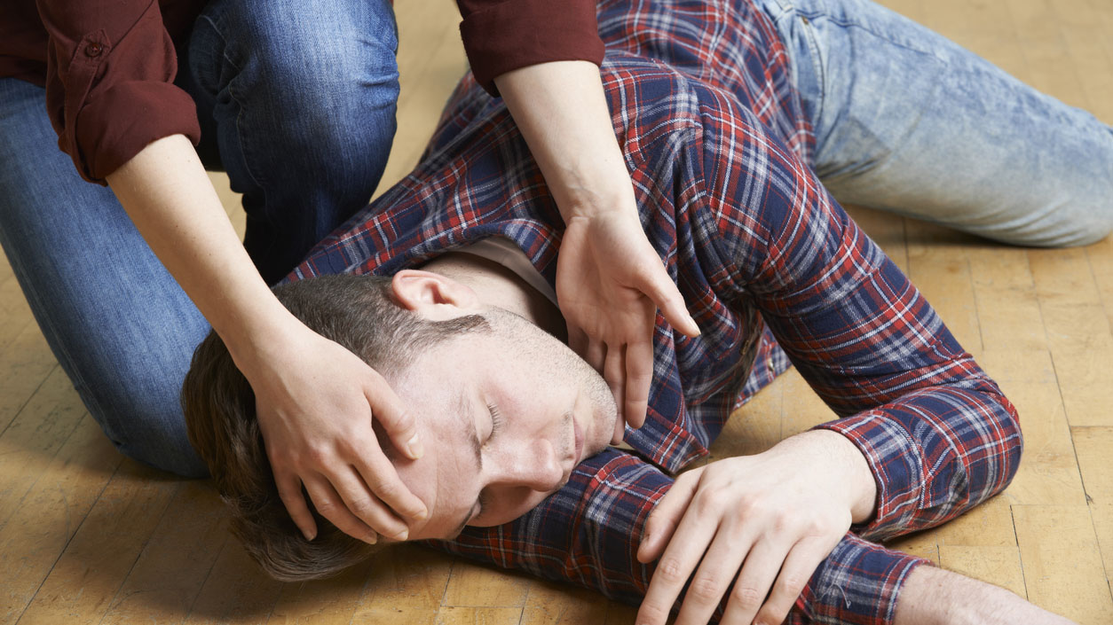Man being put in a recovery position.