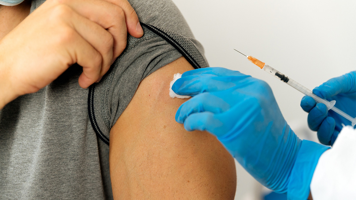 A doctor preparing to administer a vaccine in a patient's arm