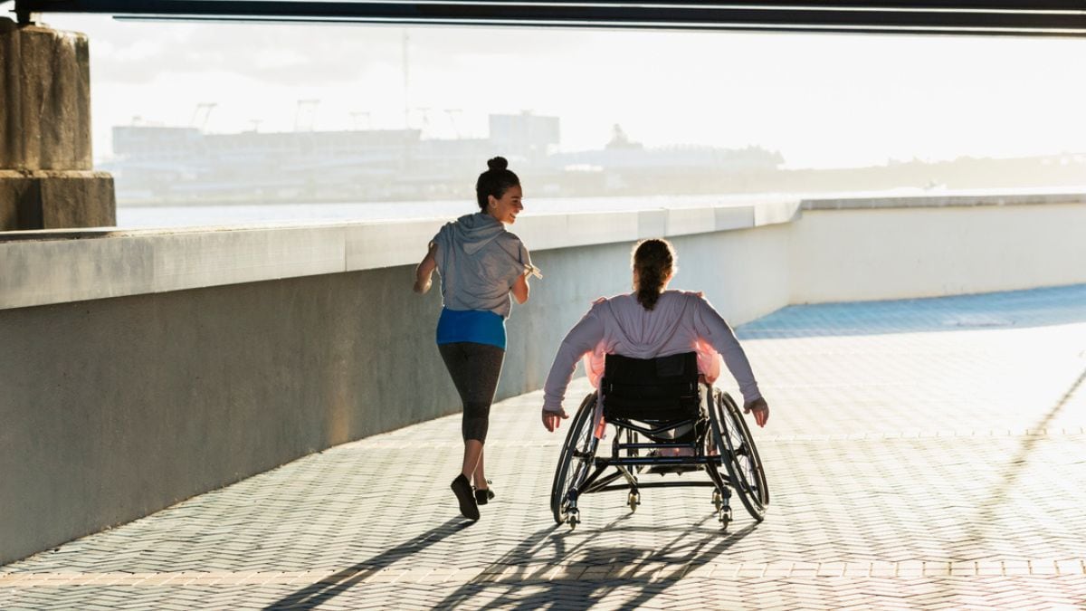Person with spina bifida exercising with a friend