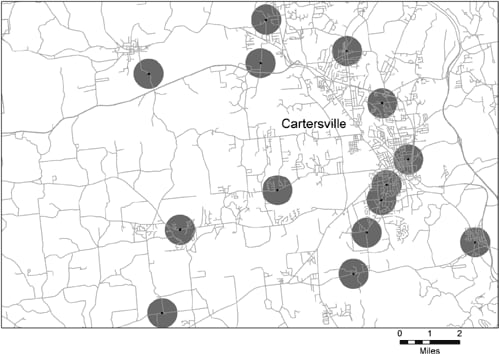 This figure is a map of a portion of Bartow County, Georgia, and the city of Cartersville; the map shows the locations of 14 schools within the approximately 160-square-mile area illustrated. Around each school location is a circle with a one-half mile radius. Only two of the circles have any portion that overlaps another circle.