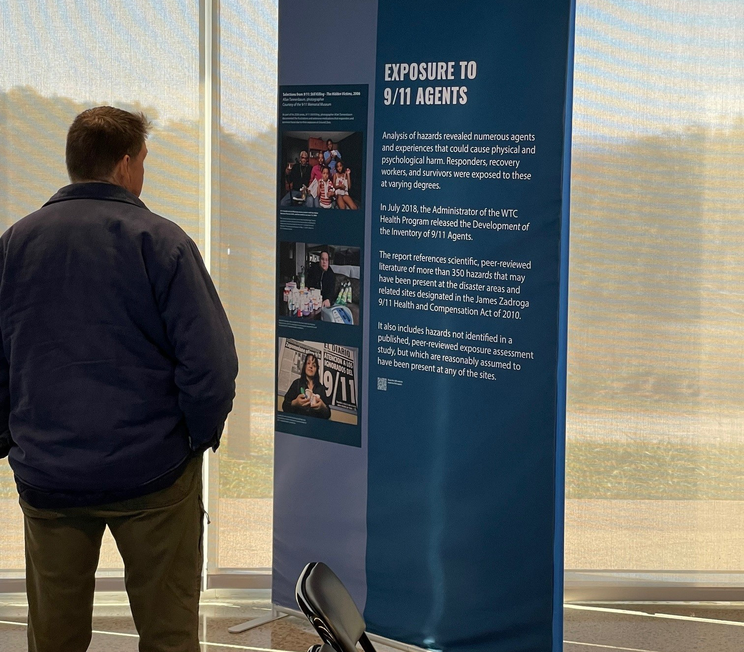 Visitor reading display panel titled ‘Exposure to 9/11 Agents.’