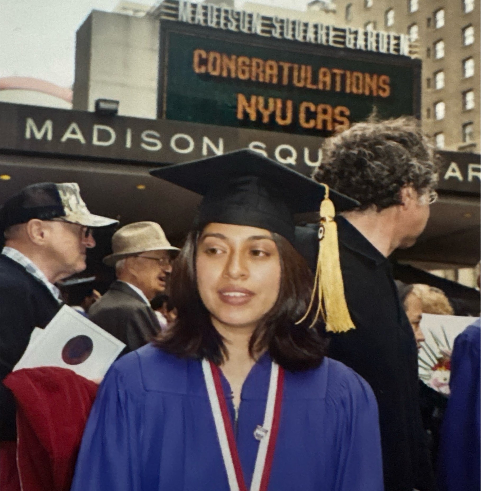 Nadia wearing a cap and gown at her NYU graduation in 2003.