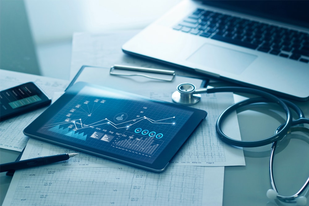 Laptop, tablet and stethoscope on a table
