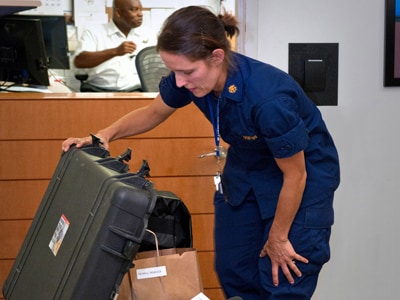 Photo: CDC Disease detective Rebecca checks her trunk before deploying to West Africa.