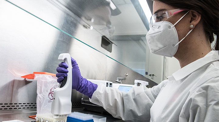 Scientist preparing patients' samples for SARS-CoV-2 antibody testing