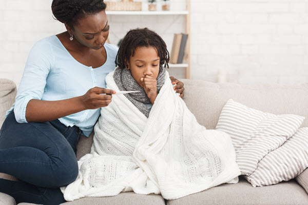 Mother taking child's temperature.