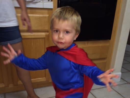 Alex in a superhero costume.