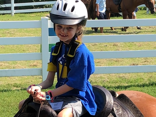 Lauren riding a horse.