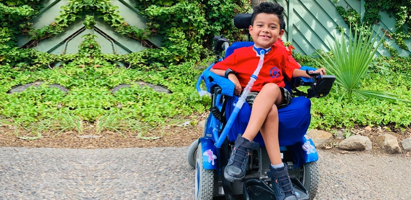 Francisco smiling in his power chair.