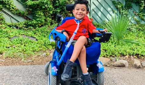 Francisco smiling in his power chair.