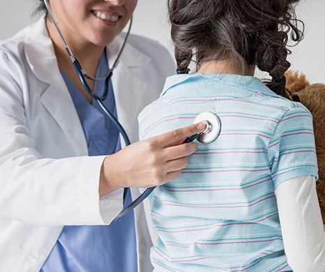 doctor examining a young child
