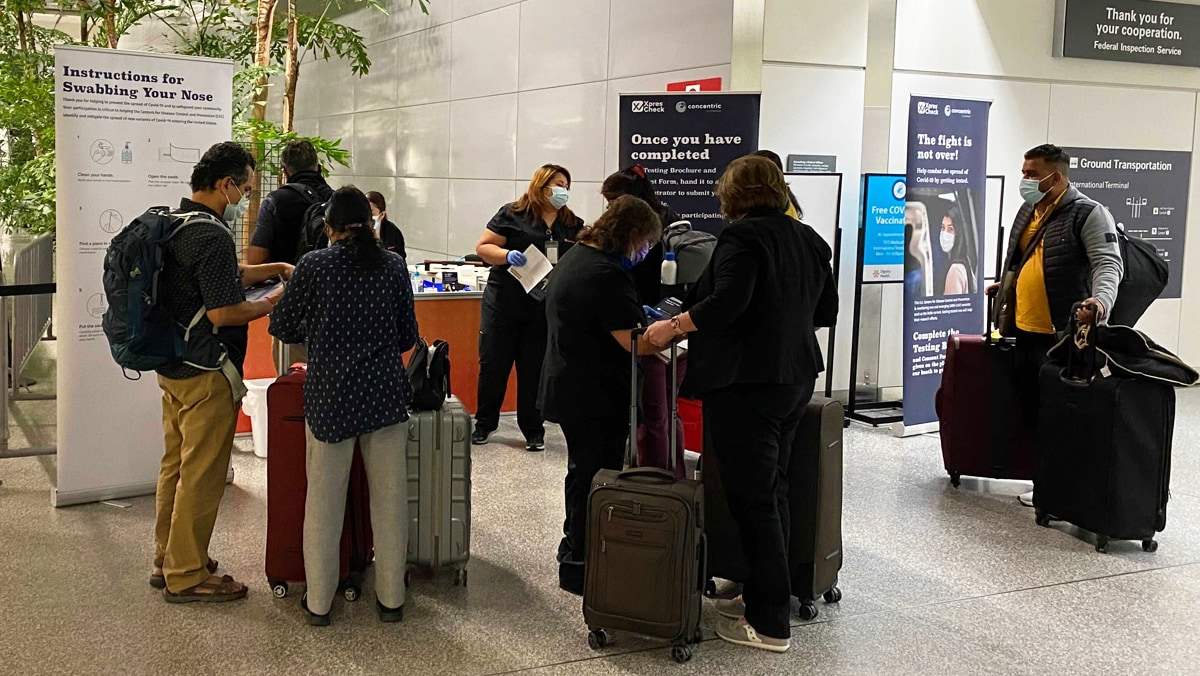 Travelers gather at a testing station in the San Francisco International Airport