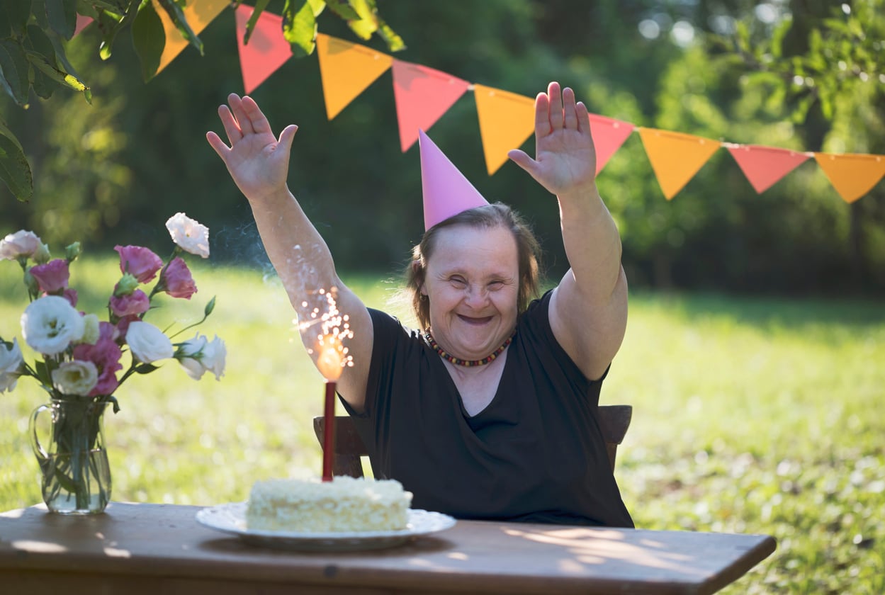 Older Adult woman with Down syndrome celebrating a birthday