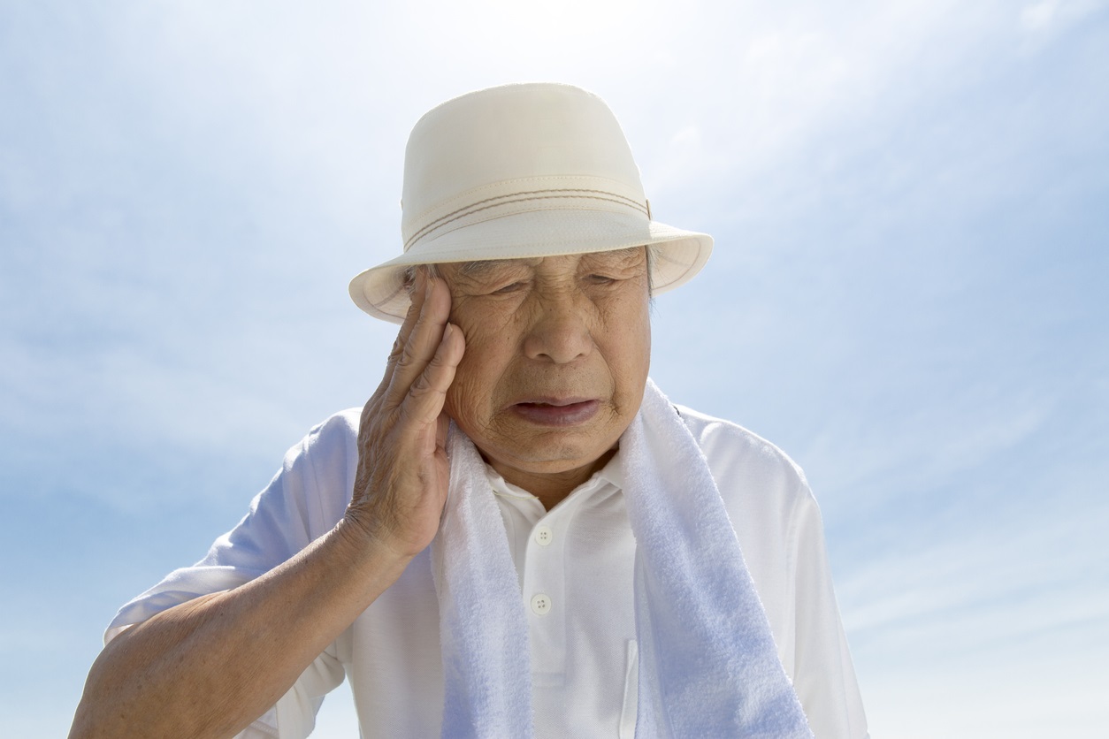Senior Asian man showing signs of heat stroke