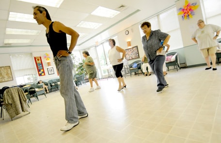 adults in a group taking a dance class