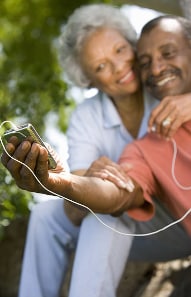 Elderly couple with a cellphone and ear buds