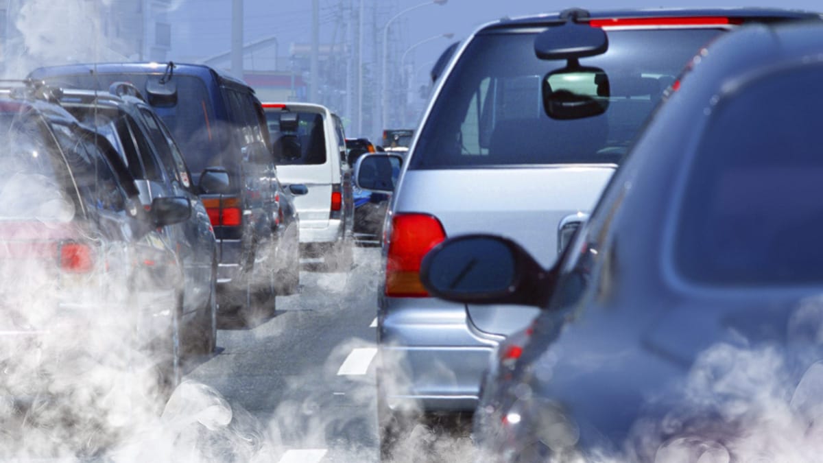 Vehicles in traffic emitting air pollution