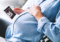 pregnant lady holding ultrasound image
