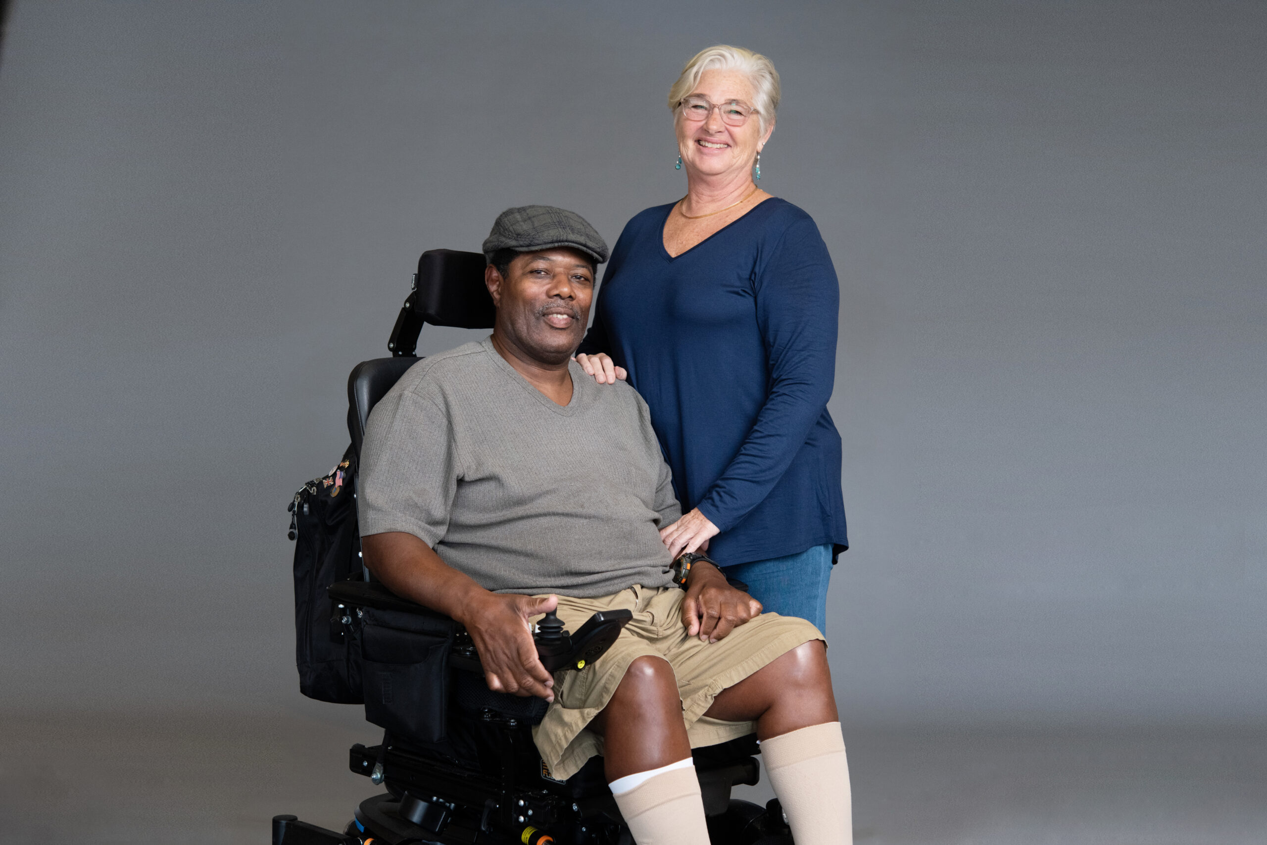 photo of an African-American male in a wheelchair with his wife.