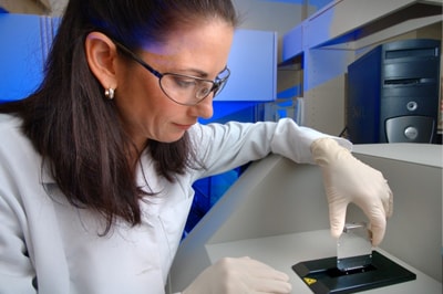 A scientist working with samples in a lab.