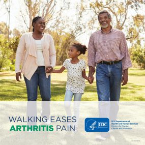 Older black couple walking in park. Text says "walking eases arthritis pain."