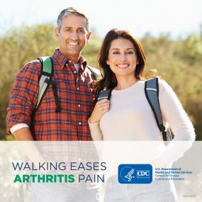 Latino couple hiking in the woods. Text says "Walking eases arthritis pain."